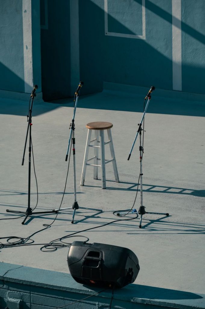 An empty stage setup with a bar stool and three microphones in Vancouver.